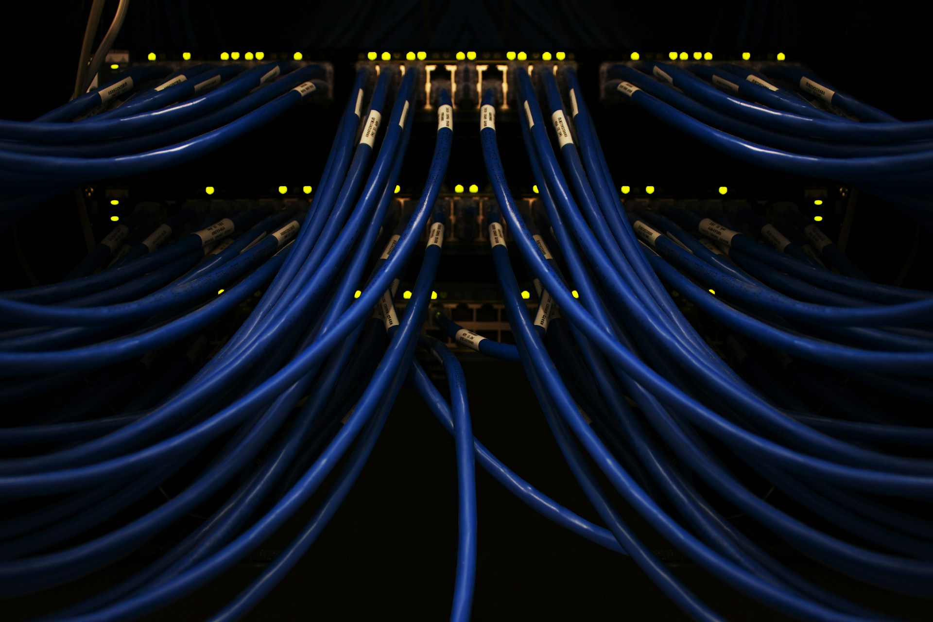 Network cables and server infrastructure in a modern data center, representing data flows and connectivity.